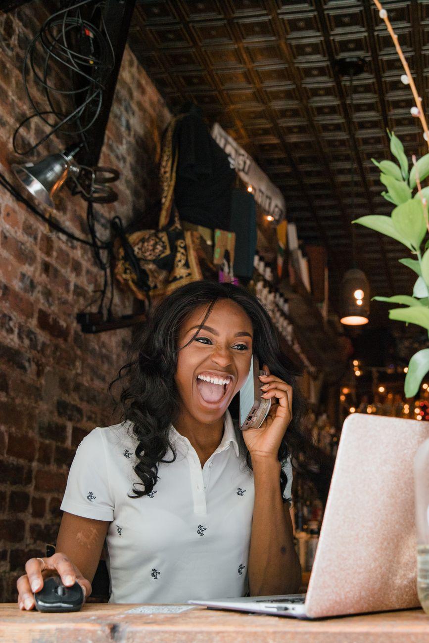 A business owner smiling while working from her laptop