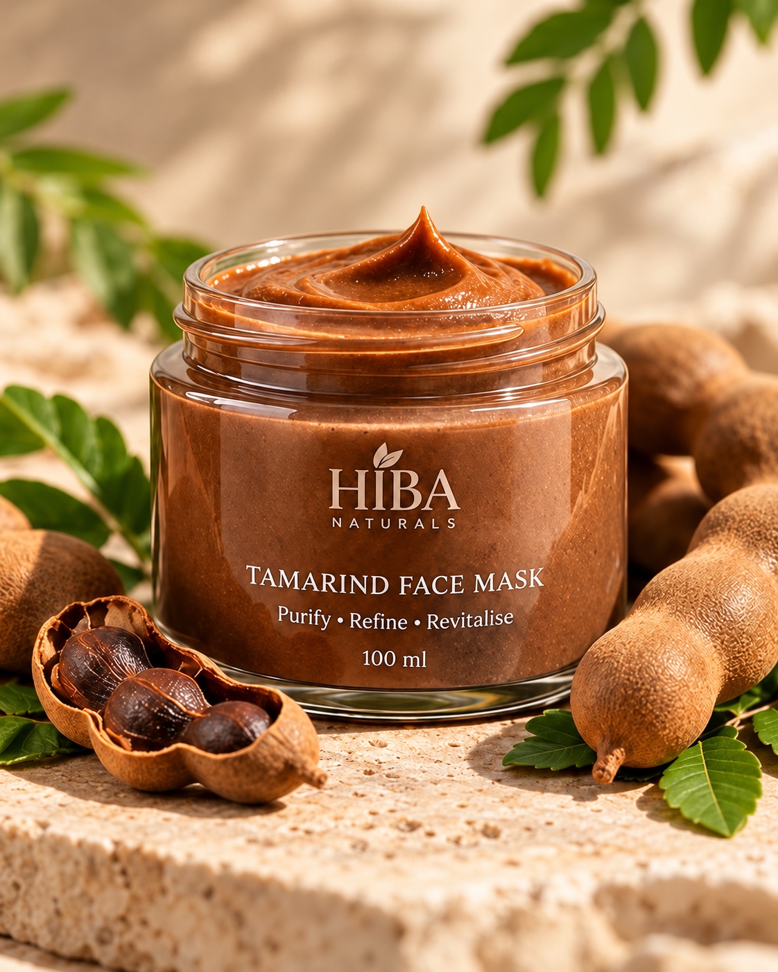 100 ml jar of Hiba Naturals Tamarind Face Mask, styled with tamarind pods and leaves
